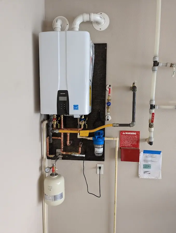 Professional plumber installing copper piping in a Chilton home